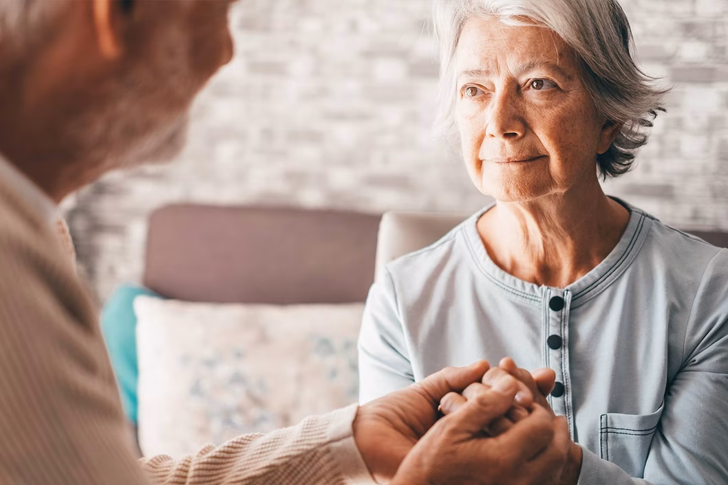 Photo of a woman and a man clasping hands