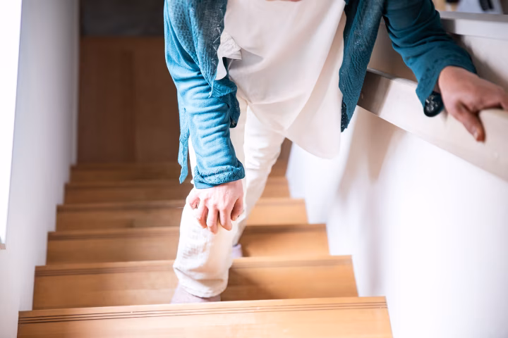 Senior woman walking up stairs