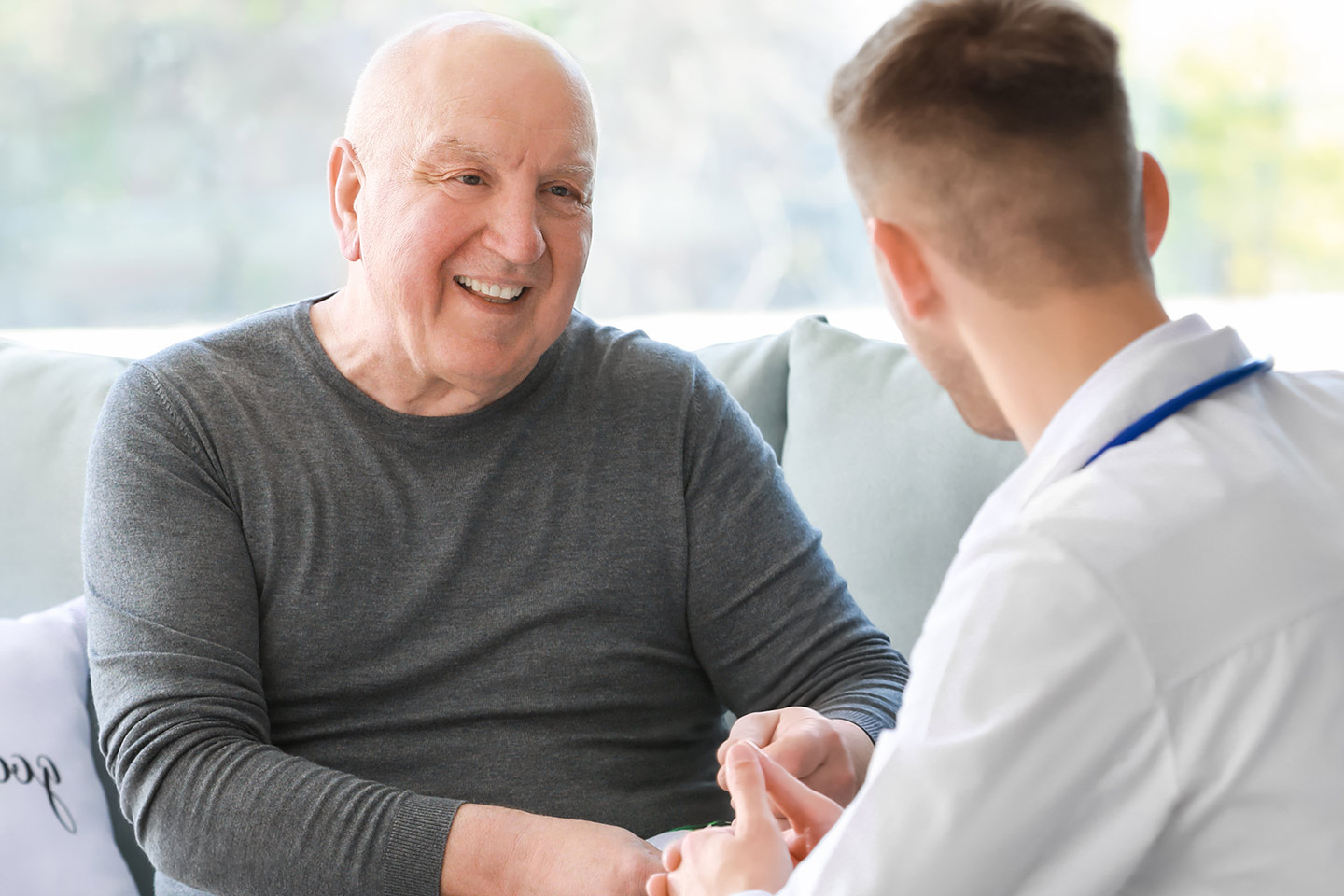 Picture of an older man talking to a younger man