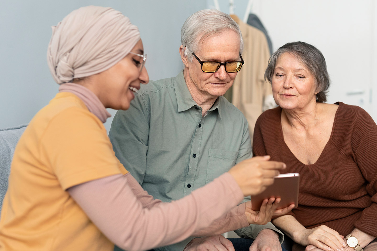 Photo of three people looking at a booklet