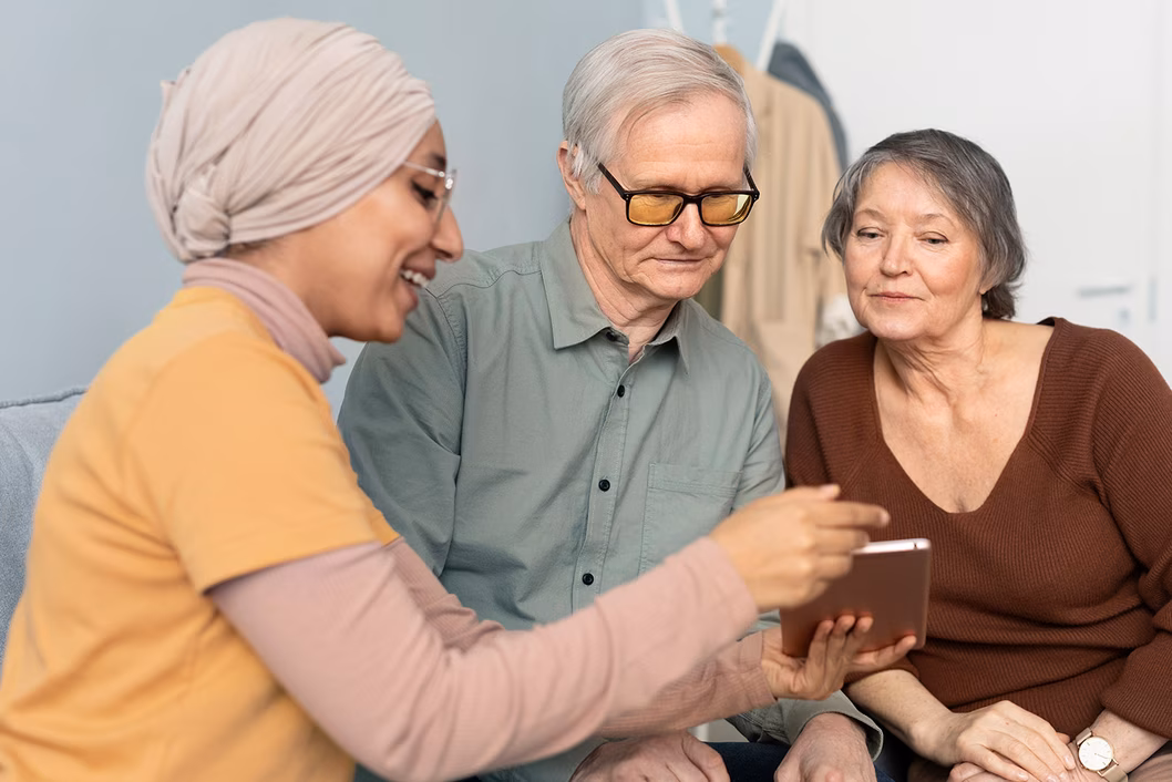 Photo of three people looking at a booklet