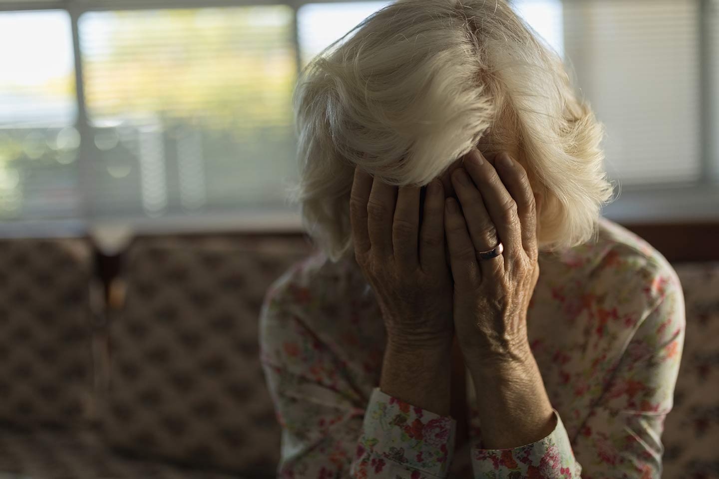 Photo of woman with her face in her hands
