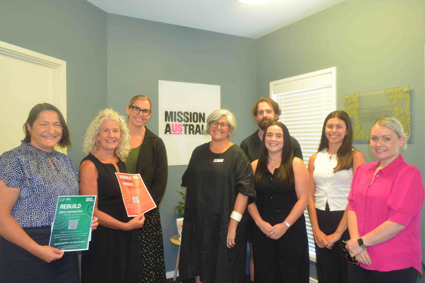 Photo of a group of smiling people in an office