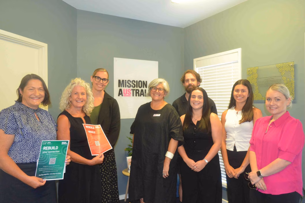 Photo of a group of smiling people in an office