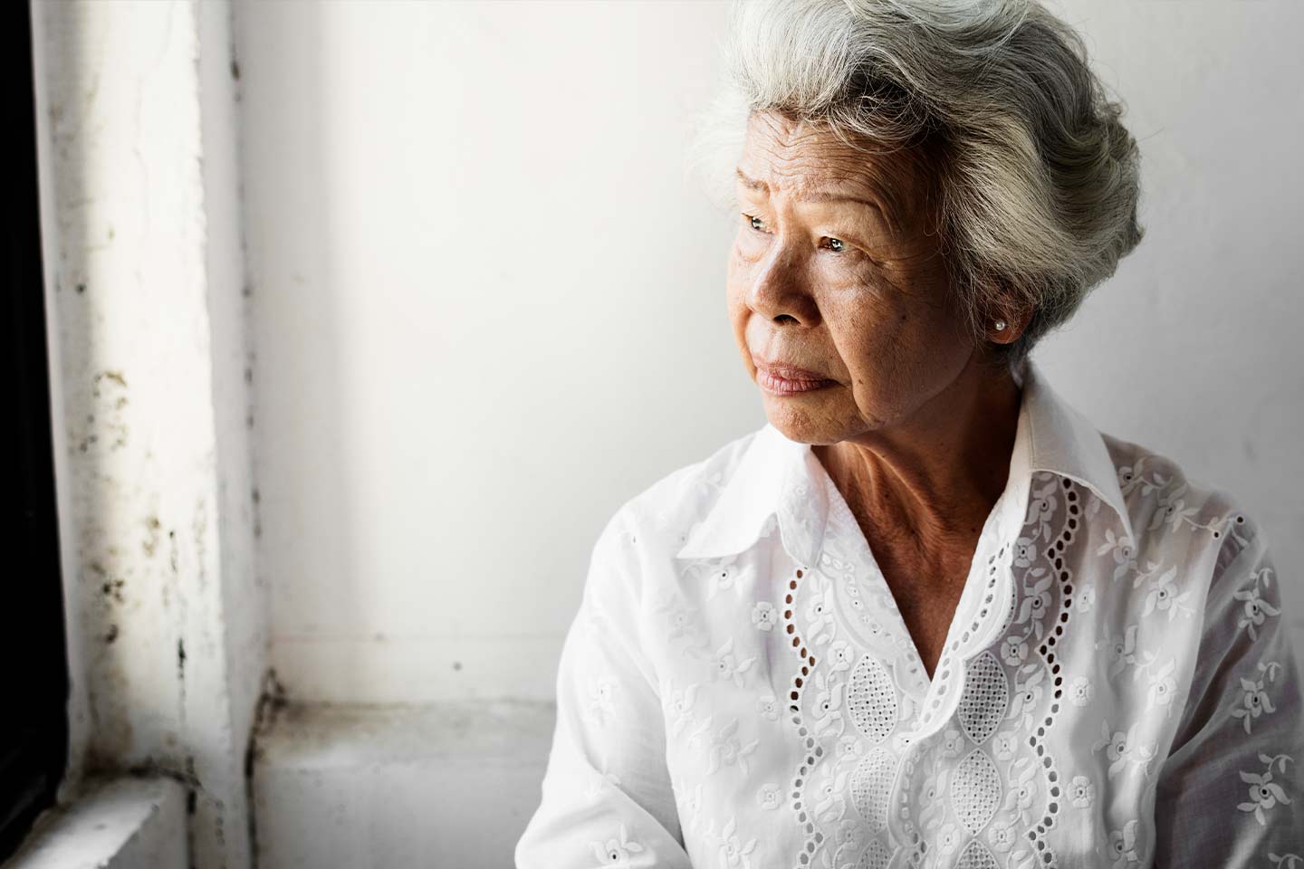 Photo of a woman in a pretty broderie anglaise blouse