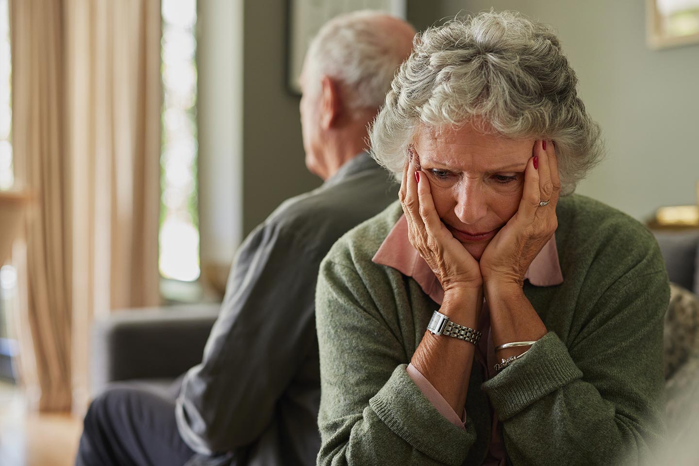 Photo of a woman sitting with her chin in her hands