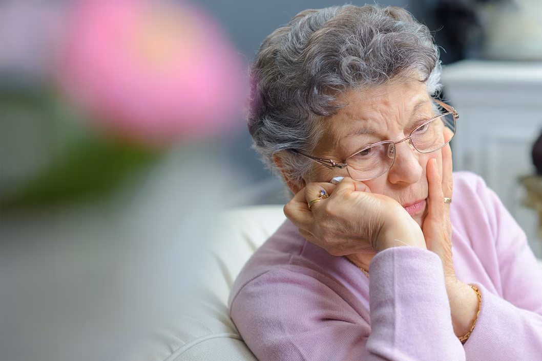 Photo of a woman wearing a lilac jumper