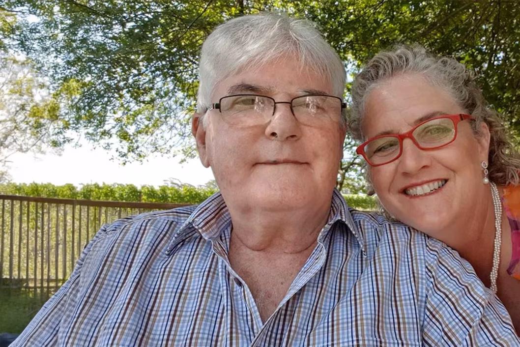 Photo of a smiling couple in a green park