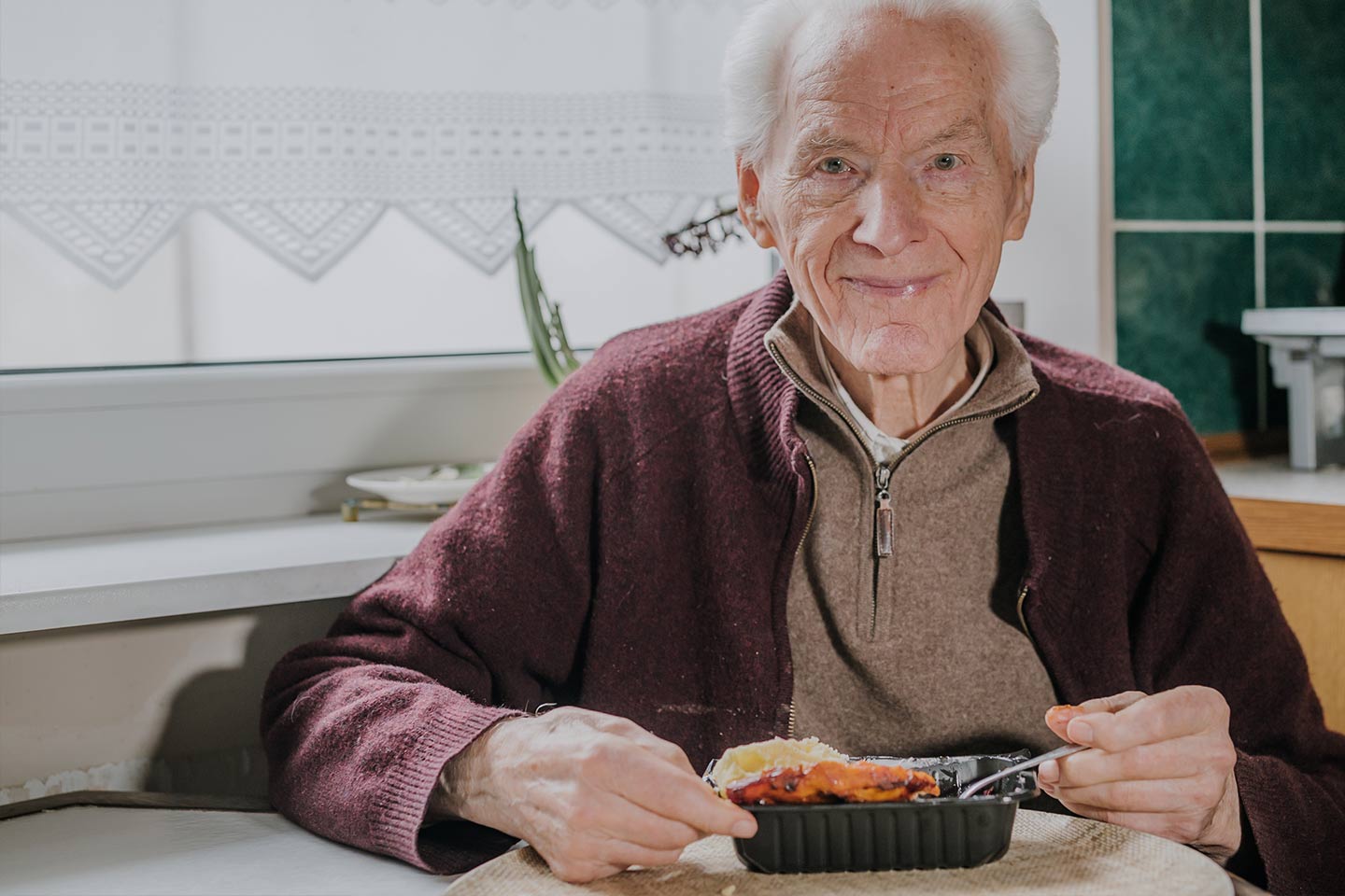 Photo of smiling older man about to eat a ready meal