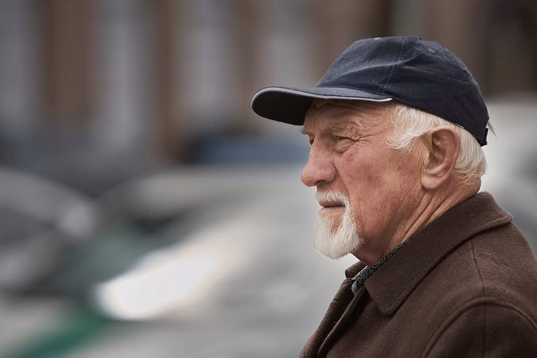 Photo of bearded man wearing a cap