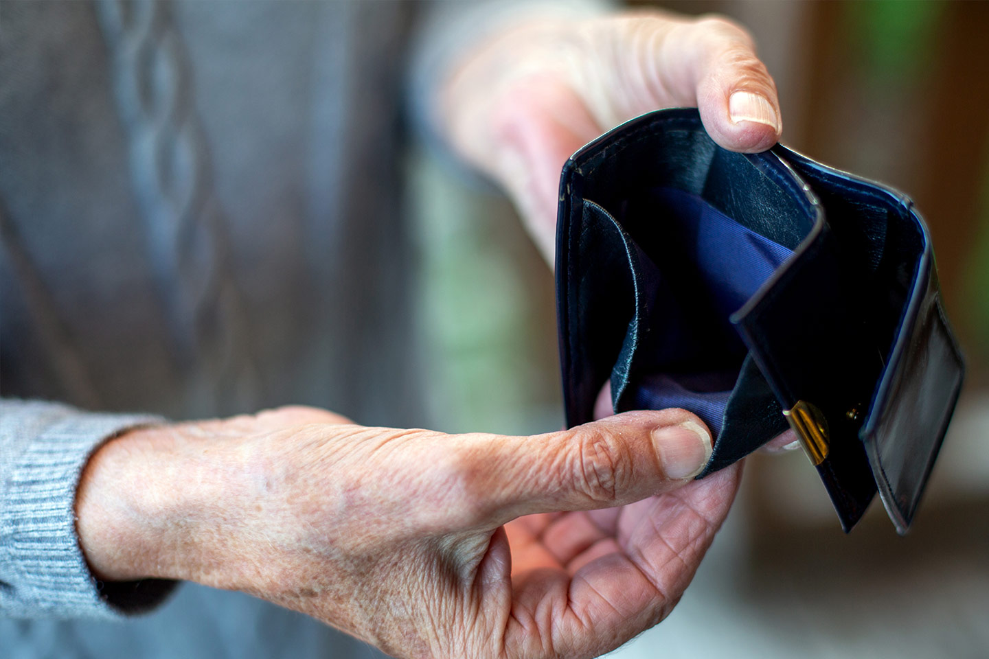 Photo of hands holding open an empty wallet