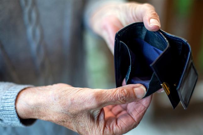 Photo of hands holding open an empty wallet