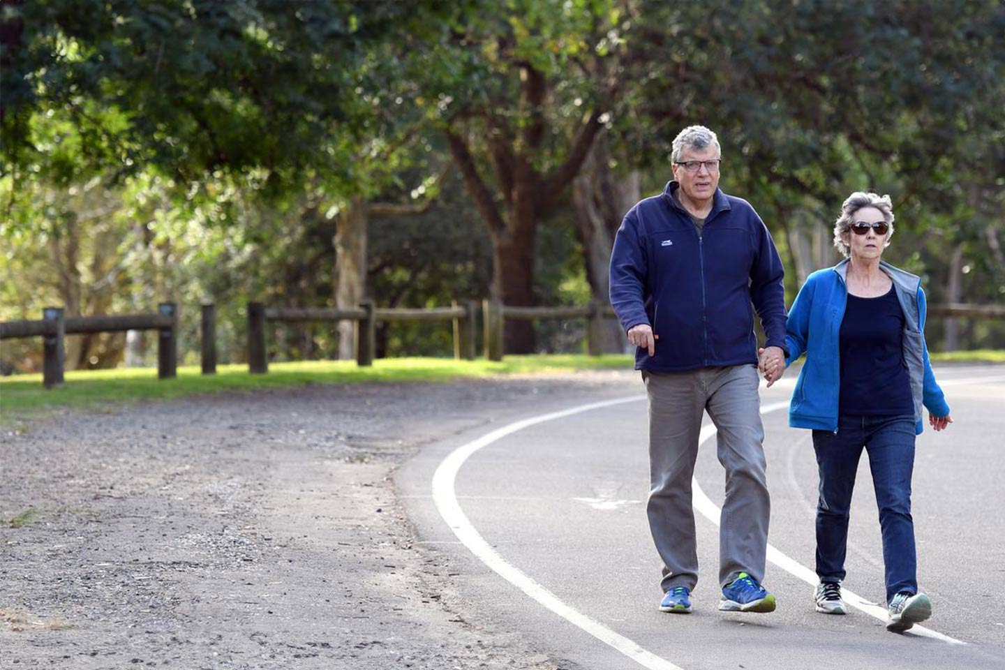 Photo of couple holding hands on a walk