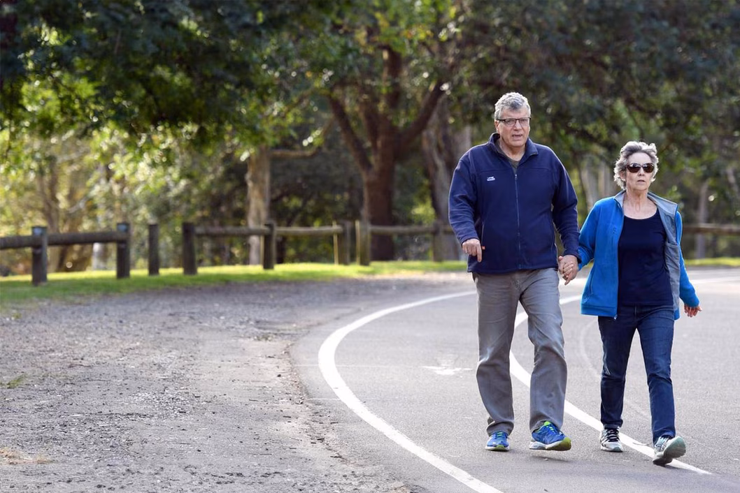 Photo of couple holding hands on a walk