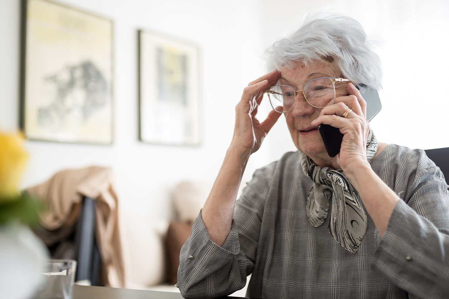 Photo of a woman in a grey blouse on the phone