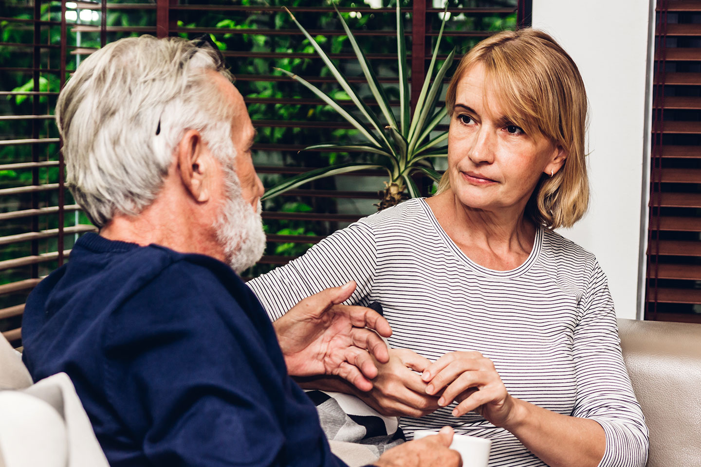 Image of an older man talking with an older woman about financial matters