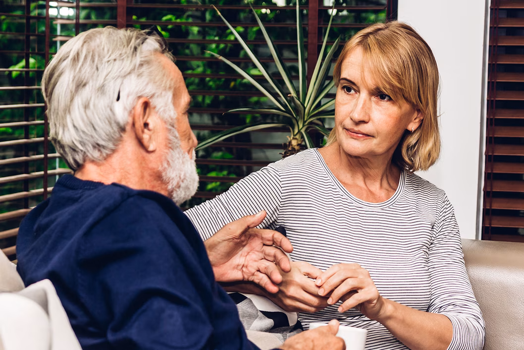 Image of an older man talking with an older woman about financial matters