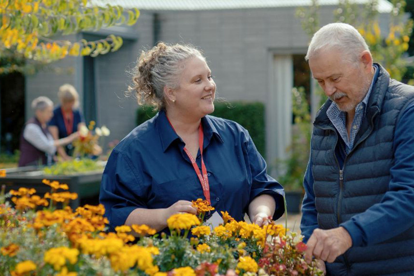 Photo of two people gardening