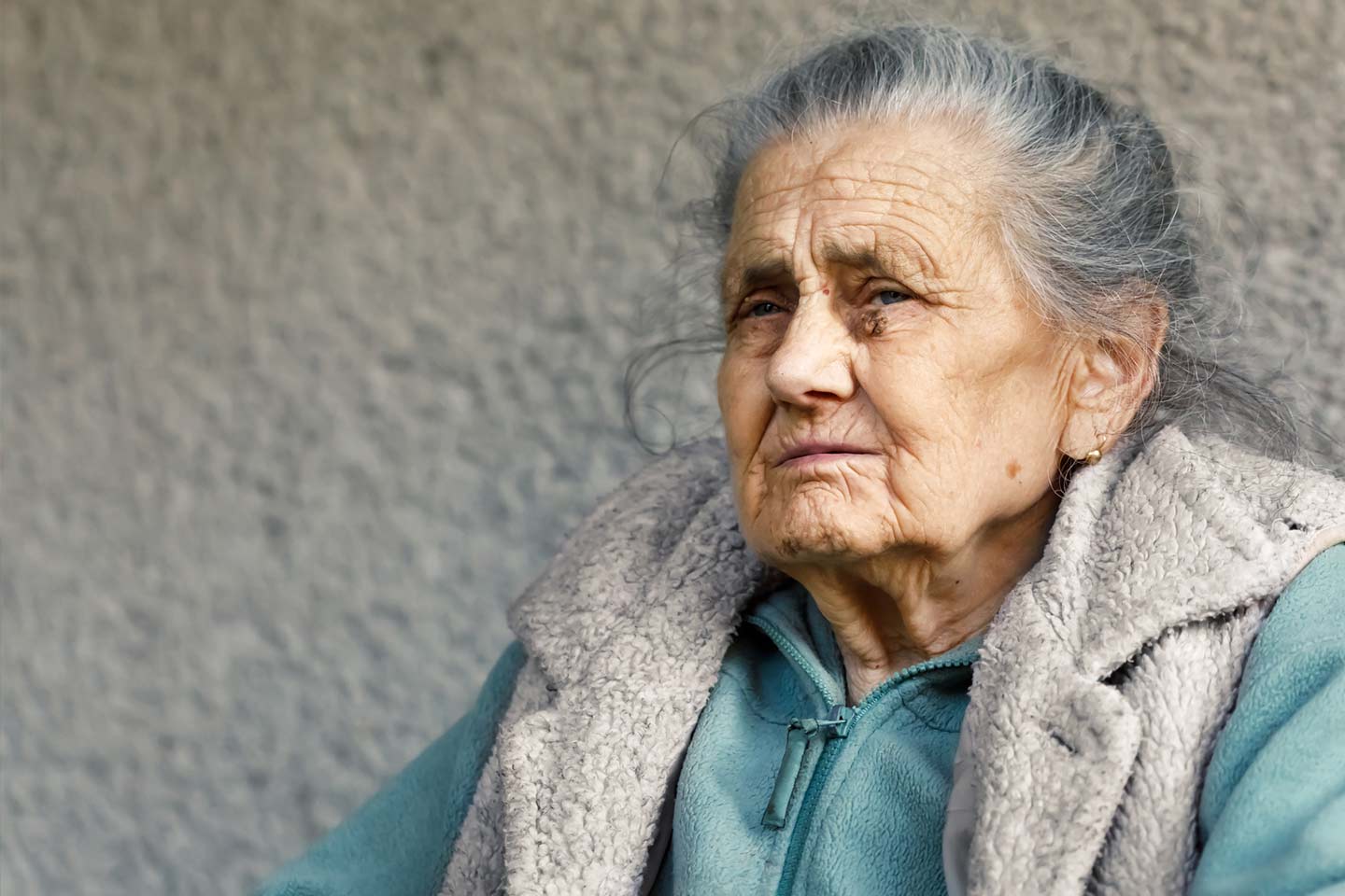 Photo of a woman wearing pale teal and cream sherpa jackets