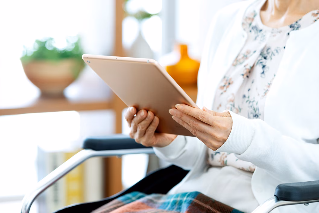 Photo of woman holding a computer tablet