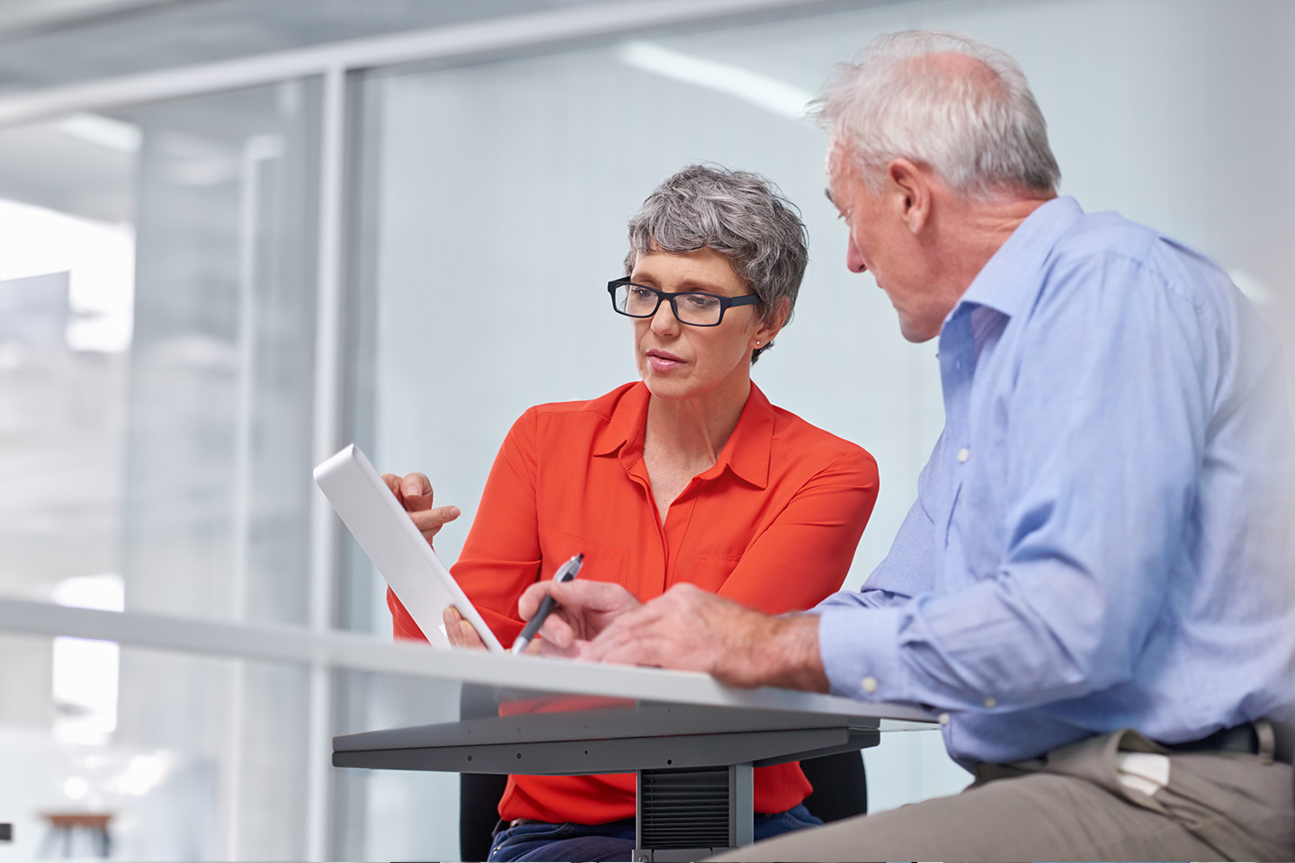 Photo of a woman in an orange shirt and a man wearing blue