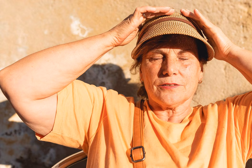 Photo of a woman in the sunshine wearing a hat
