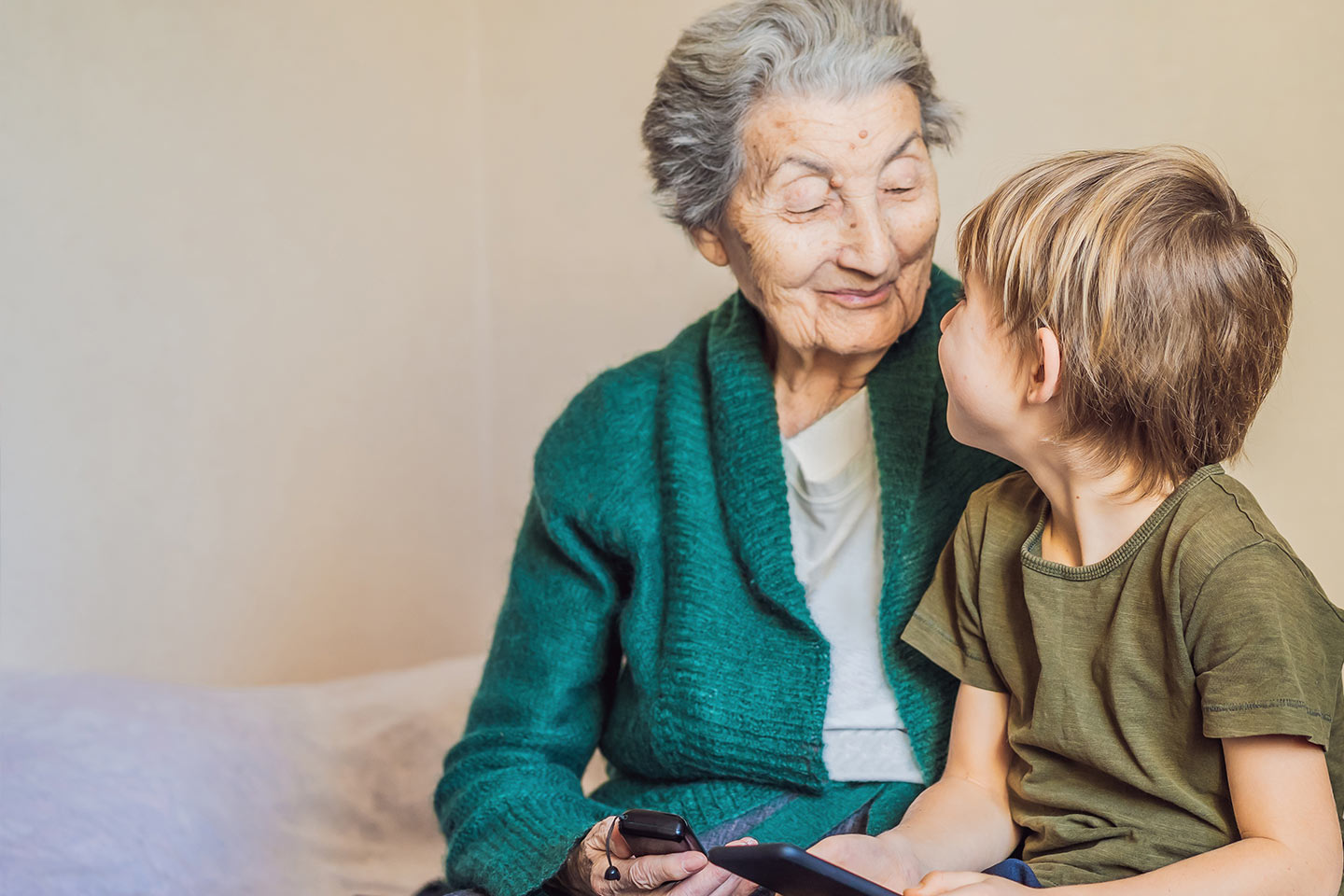 Photo of a senior woman and a young child both wearing green