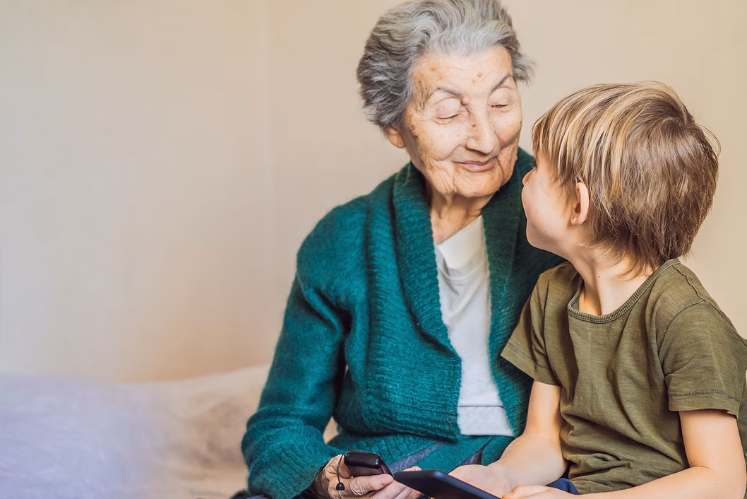 Photo of a senior woman and a young child both wearing green