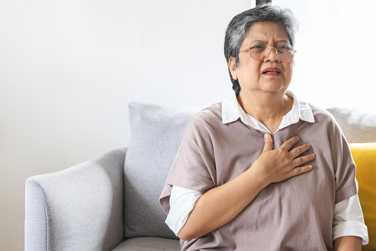 Photo of a woman in a mauve top looking anguished