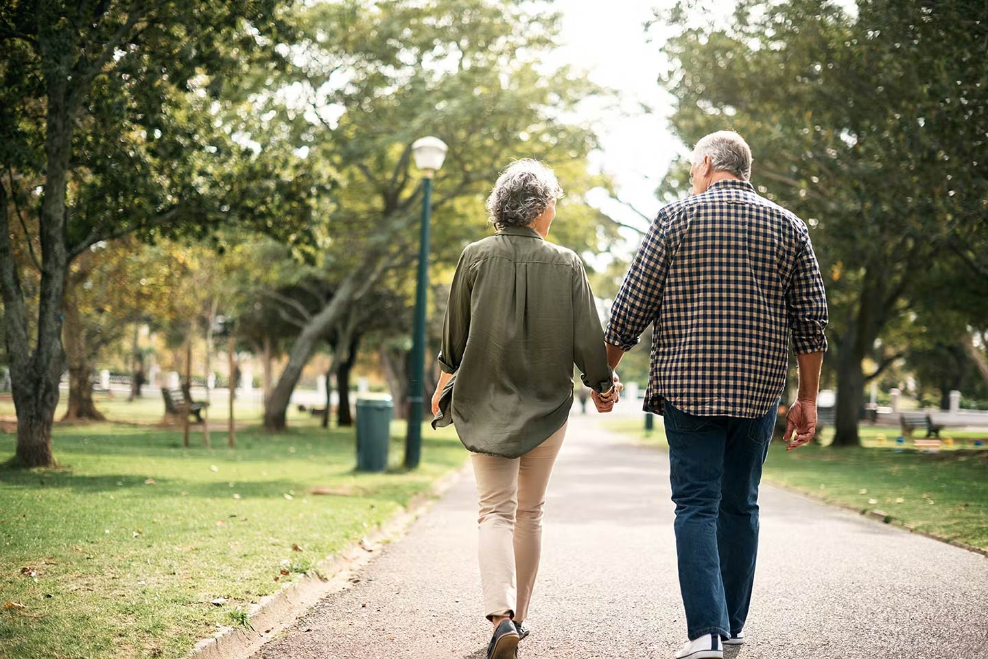 Free Course for Mental Health - picture of a man and a woman walking in a park and holding hands.