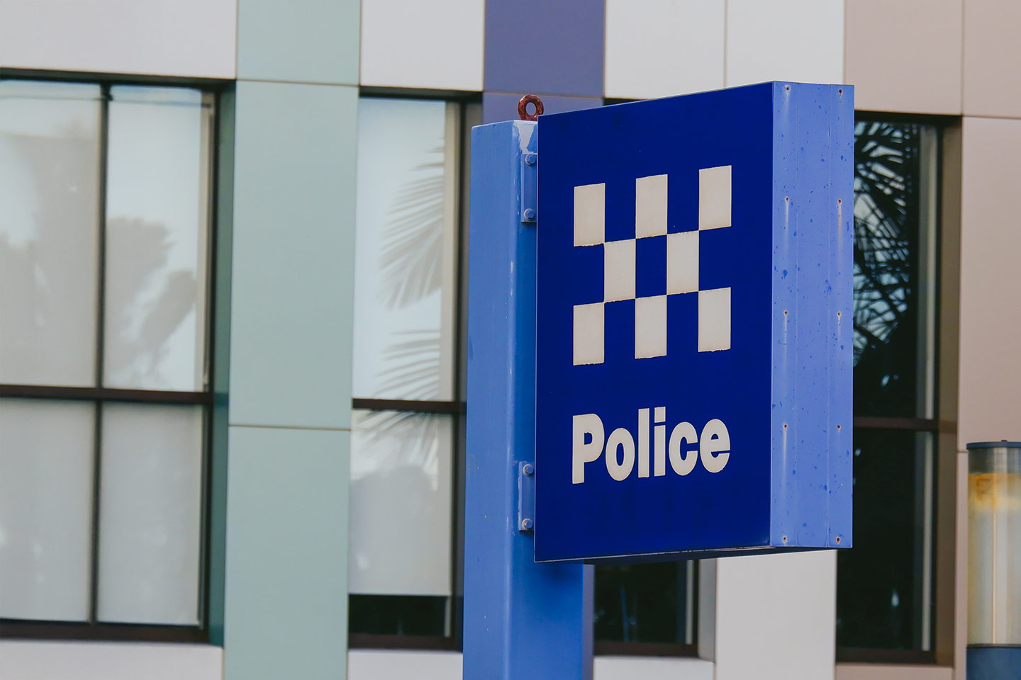 Photo of a blue police sign outside a building