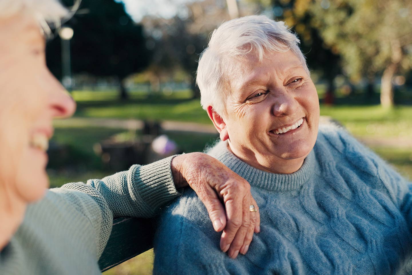 Photo of woman in a blue cable knit jumper smiling