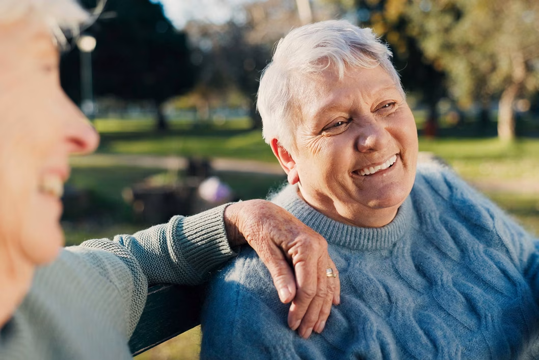 Photo of woman in a blue cable knit jumper smiling