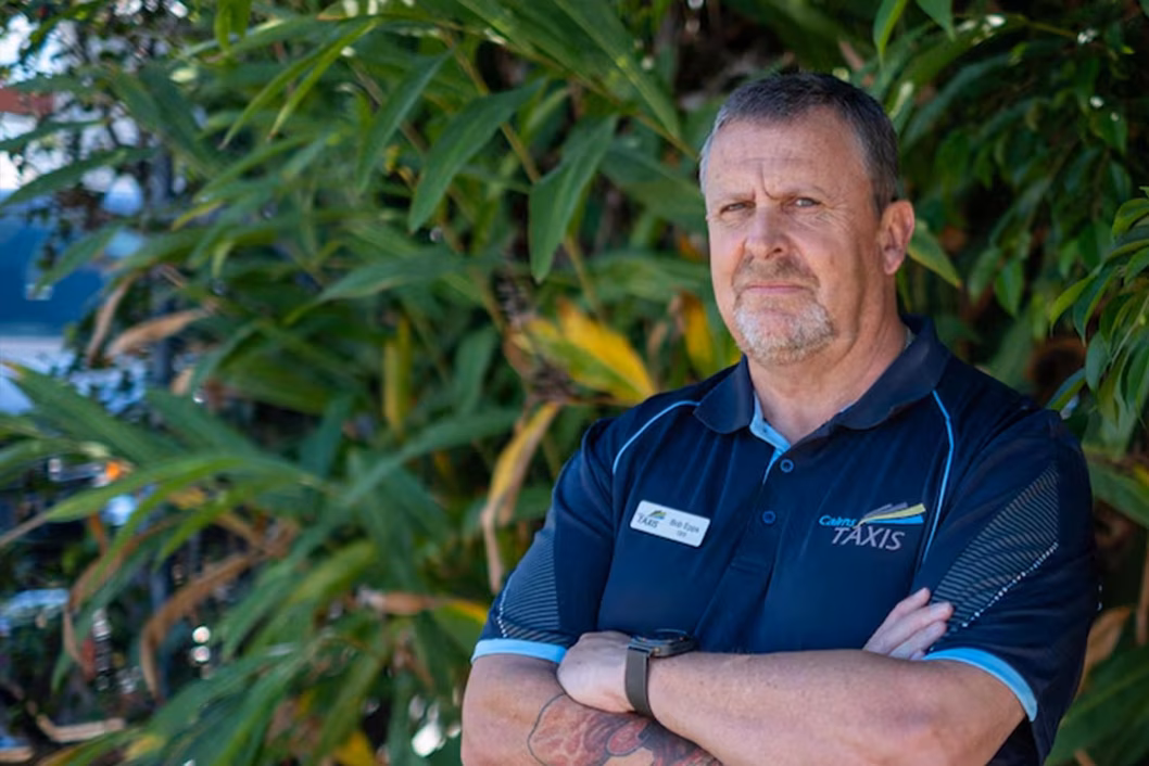 Photo of a man standing with his arms crossed