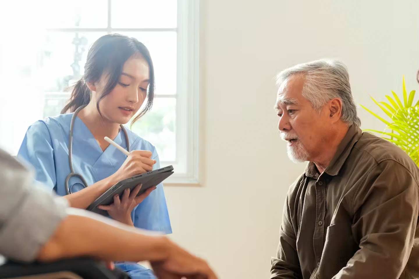 Photo of health worker talking with older man