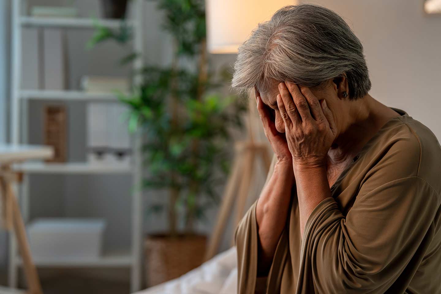 Photo of a woman pressing her hands to her face