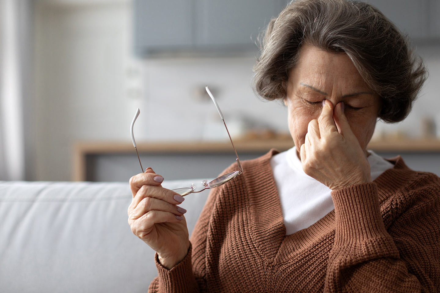 Photo of a woman pinching the bridge of her nose