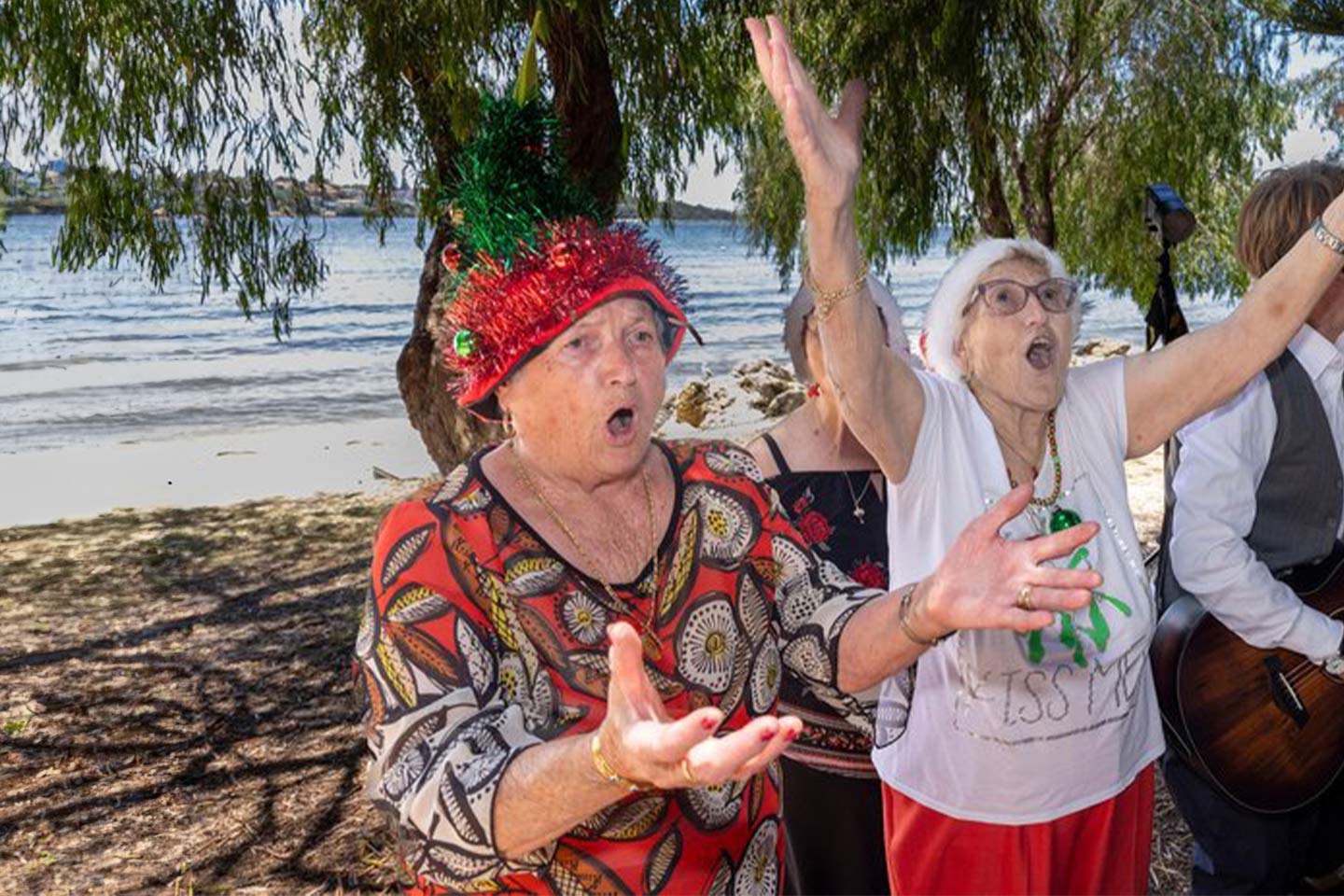 Photo of women singing with gusto on a beach