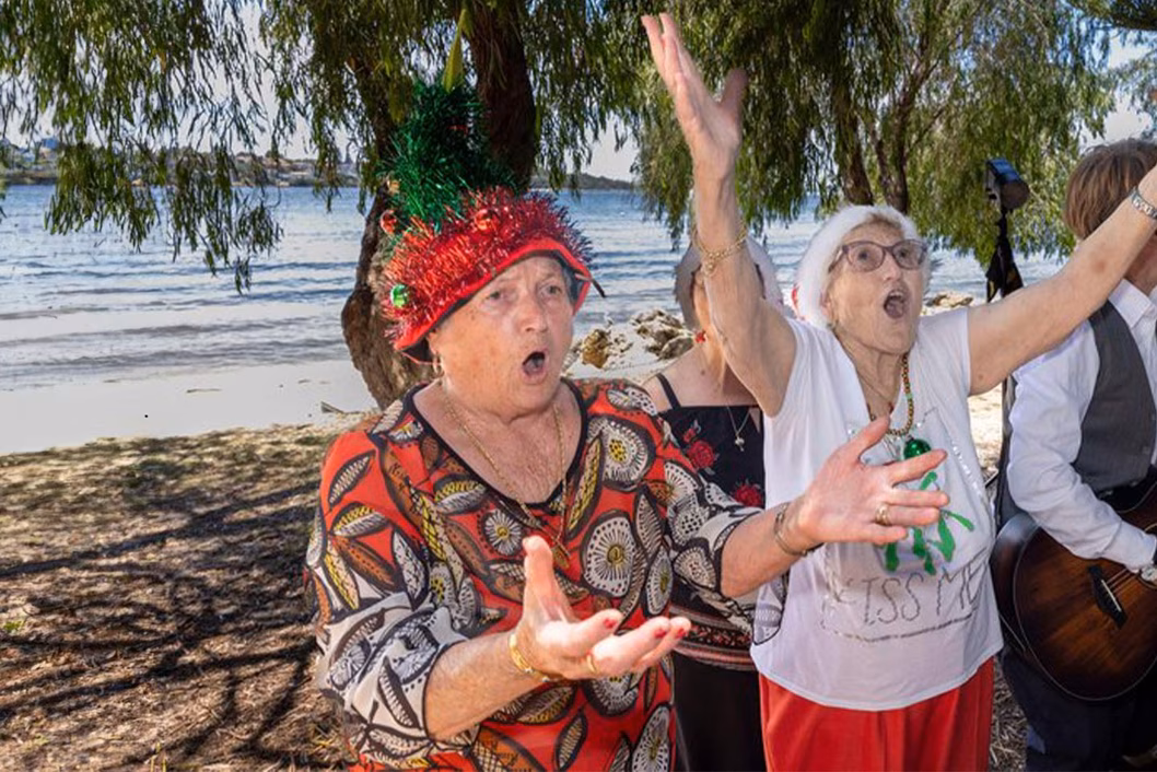Photo of women singing with gusto on a beach