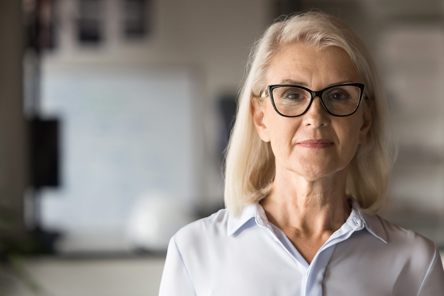 Photo of woman with long blonde bob and black glasses