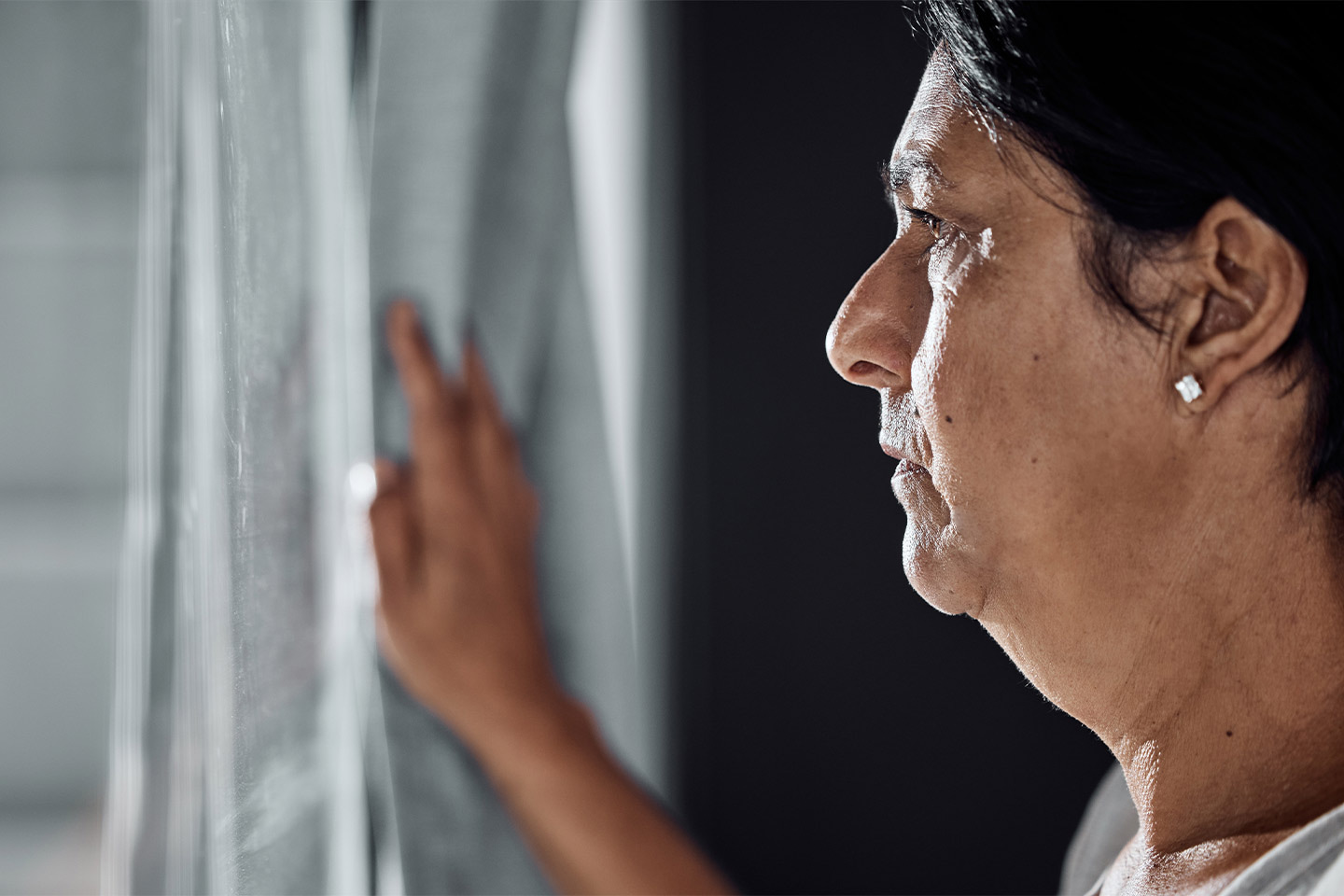 I age of an older woman looking out a window