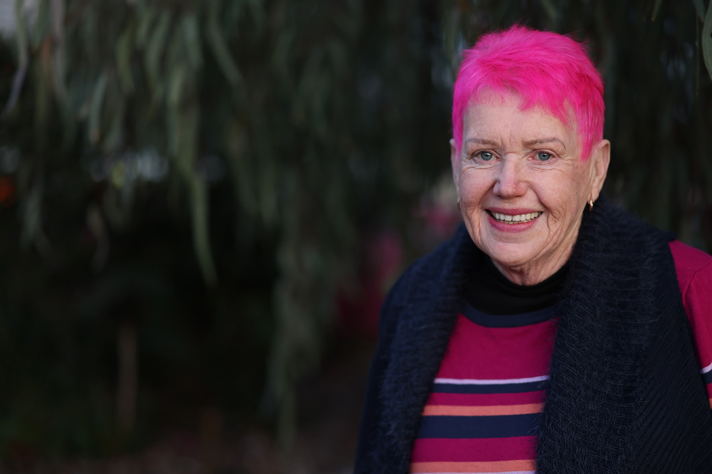 Photo of smiling lady with hot pink hair