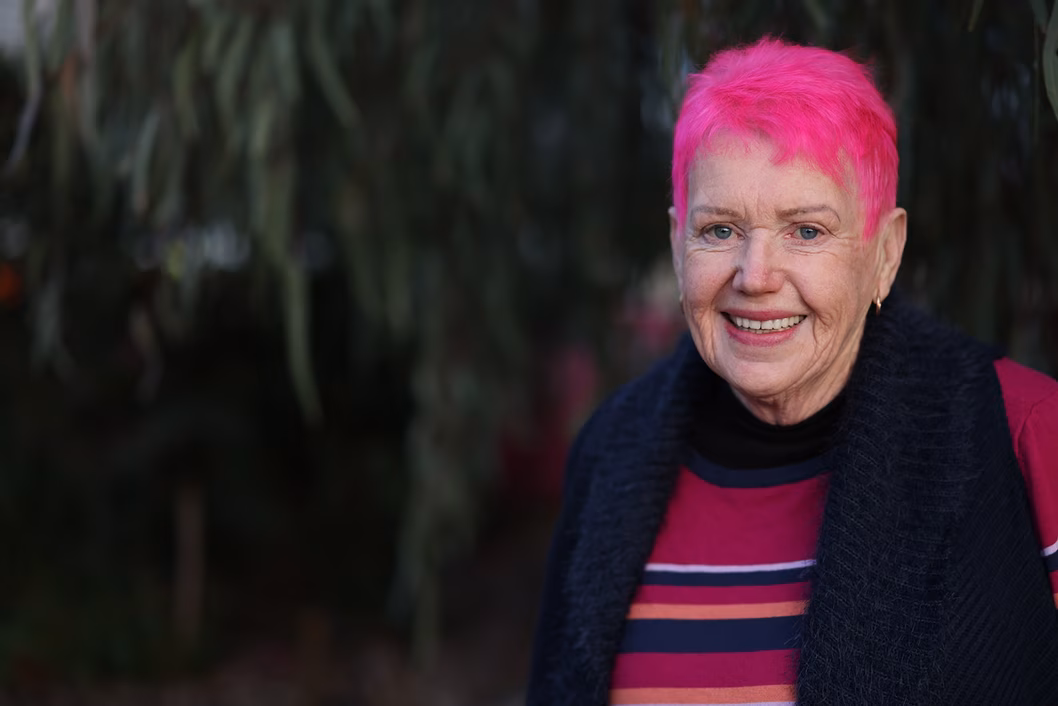Photo of smiling lady with hot pink hair