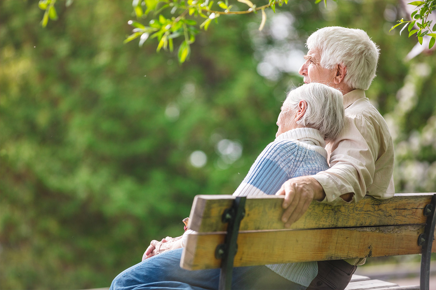 Photo of a couple sitting together on a park bench