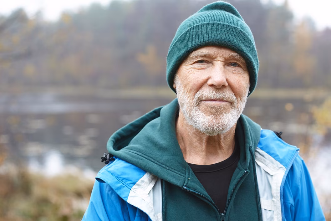 Photo of outdoorsy man in green beanie and jacket
