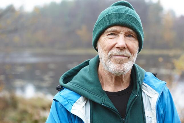 Photo of outdoorsy man in green beanie and jacket