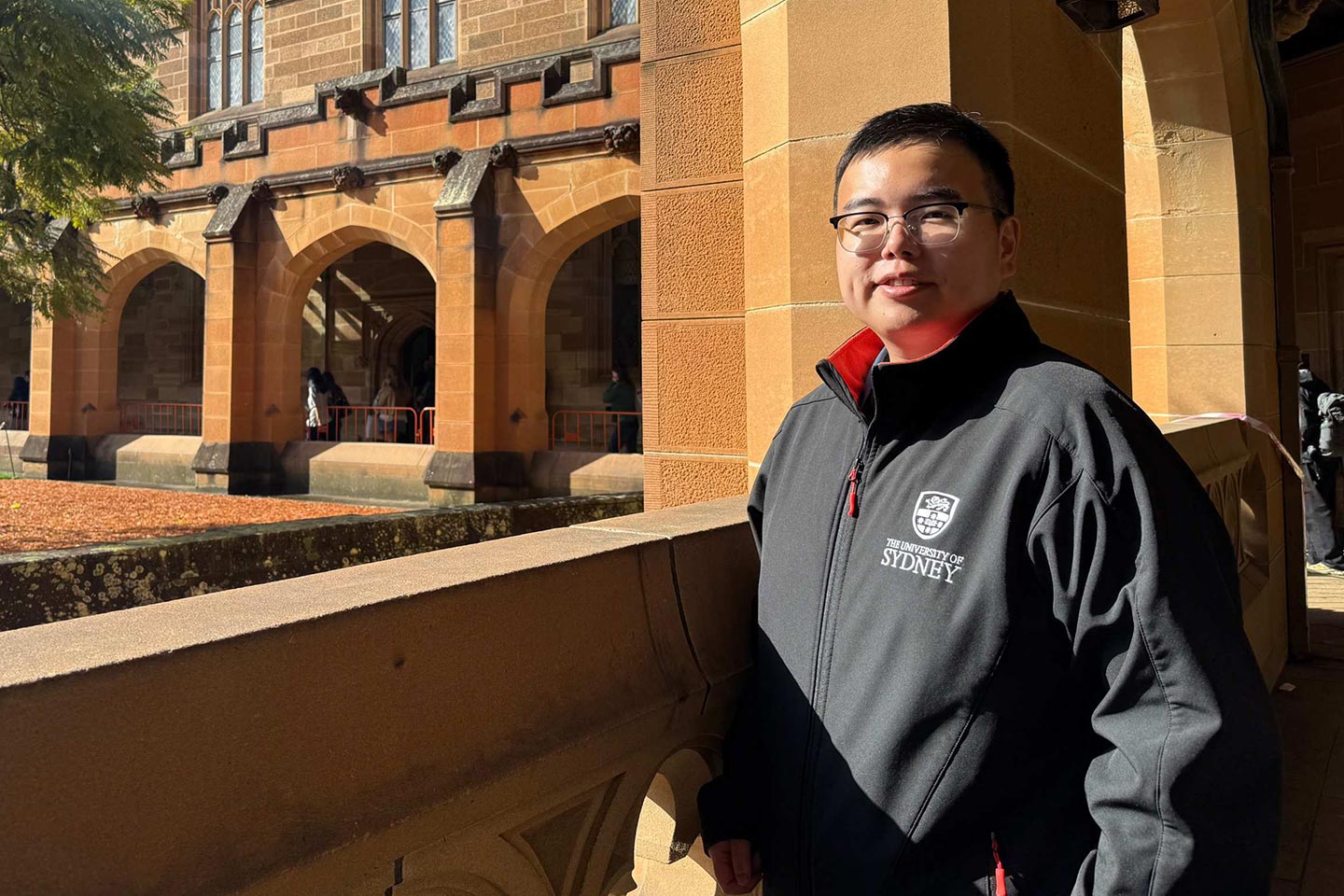 Photo of a student in the cloisters of Sydney University