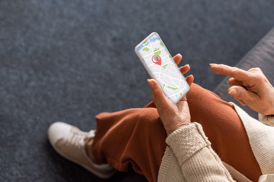 Image of an older woman looking at her tracking on her smartphone