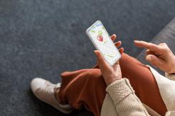 Image of an older woman looking at her tracking on her smartphone