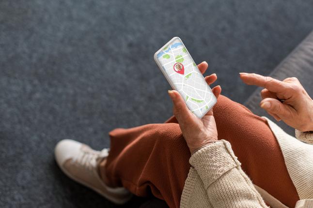Image of an older woman looking at her tracking on her smartphone